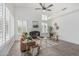 Bright living room with vaulted ceilings, a cozy fireplace, and elegant wood-look tile flooring at 921 N Oxford Ln, Chandler, AZ 85225