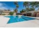 Inviting backyard pool featuring cool blue waters, white concrete trim, and lush landscaping with palm trees at 921 N Oxford Ln, Chandler, AZ 85225
