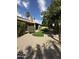 Expansive backyard with desert landscaping, palm trees, and well-manicured artificial grass at 9733 W Mcrae Way, Peoria, AZ 85382