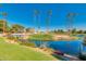 Scenic golf course with a tranquil pond, mature palm trees, and well-maintained greens at 9733 W Mcrae Way, Peoria, AZ 85382
