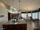 Spacious kitchen featuring a large island, modern appliances, skylight, and an adjacent dining area at 9733 W Mcrae Way, Peoria, AZ 85382