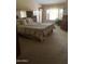 Comfortable bedroom with large window, plush carpeting, and ample natural light at 9733 W Mcrae Way, Peoria, AZ 85382