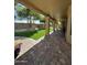 Covered patio with brick flooring overlooks a lush backyard with artificial grass at 9733 W Mcrae Way, Peoria, AZ 85382