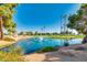 Picturesque view of a pond on the golf course with lush landscaping and palm trees at 9733 W Mcrae Way, Peoria, AZ 85382