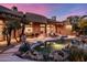 Resort style backyard features a pool, spa, patio, dining area, fire pit, BBQ, and lush desert landscaping at 9913 E Quarry Trl, Scottsdale, AZ 85262