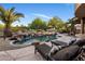 Resort-style backyard with a rock waterfall pool, lounge chairs, and lush landscaping at 9913 E Quarry Trl, Scottsdale, AZ 85262