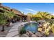 Backyard oasis with rock waterfall pool, lush landscaping, and plenty of patio space at 9913 E Quarry Trl, Scottsdale, AZ 85262