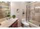 Traditional bathroom with a shower-tub combination, wooden vanity, and neutral tile at 9913 E Quarry Trl, Scottsdale, AZ 85262