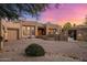 Stunning desert home featuring an attached garage and decorative desert landscaping at 9913 E Quarry Trl, Scottsdale, AZ 85262