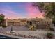 Beautiful desert home with attached garage and desert landscaping at sunset at 9913 E Quarry Trl, Scottsdale, AZ 85262