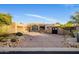 Charming single-story home featuring a well-manicured yard and an attached two-car garage at 9913 E Quarry Trl, Scottsdale, AZ 85262