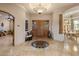 Elegant home foyer with decorative flooring, arched doorways, and clear sight lines to dining at 9913 E Quarry Trl, Scottsdale, AZ 85262