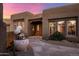 Southwestern home featuring a tiled front walkway, desert landscaping, and courtyard fountain at 9913 E Quarry Trl, Scottsdale, AZ 85262