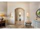 Elegant hallway with decorative niches, archway, and designer touches at 9913 E Quarry Trl, Scottsdale, AZ 85262