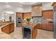 Well-appointed kitchen island with wine fridge, granite counters and stainless steel appliances at 9913 E Quarry Trl, Scottsdale, AZ 85262
