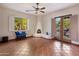 Sunlit living room featuring a fireplace, tile floors, French doors to the outside, and ample space at 9913 E Quarry Trl, Scottsdale, AZ 85262