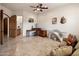 Comfortable living area with tile flooring, multiple desks, and views of the bathroom at 9913 E Quarry Trl, Scottsdale, AZ 85262