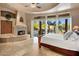 Luxurious main bedroom with fireplace and backyard patio access at 9913 E Quarry Trl, Scottsdale, AZ 85262