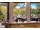 Scenic backyard view with rock waterfall and lush landscaping from kitchen at 9913 E Quarry Trl, Scottsdale, AZ 85262