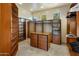 Spacious walk-in closet featuring custom wood shelving, drawers, and ample storage space at 9913 E Quarry Trl, Scottsdale, AZ 85262