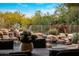 Backyard oasis featuring a rock waterfall pool, lush landscaping, and mountain views at 9913 E Quarry Trl, Scottsdale, AZ 85262