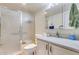 Bathroom with a frosted glass shower, white vanity, and grey countertop at 10330 W Thunderbird Blvd # A209, Sun City, AZ 85351