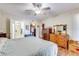 Bedroom with a ceiling fan, laminate floors, and adjoining bathroom at 10330 W Thunderbird Blvd # A209, Sun City, AZ 85351