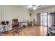 Bedroom with a ceiling fan, laminate floors, and sliding glass door at 10330 W Thunderbird Blvd # A209, Sun City, AZ 85351