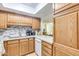 Beautiful kitchen with stainless appliances, wood cabinets, and breakfast bar at 10330 W Thunderbird Blvd # A209, Sun City, AZ 85351