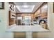 Kitchen with stainless steel appliances, stone backsplash, and a convenient breakfast bar at 10330 W Thunderbird Blvd # A209, Sun City, AZ 85351