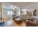 Inviting living room with hardwood floors, ceiling fans, and plush seating at 10330 W Thunderbird Blvd # A209, Sun City, AZ 85351