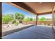 Open back patio area showcasing desert landscaping with small rocks and vibrant greenery at 13052 W Mine Trl, Peoria, AZ 85383