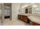 Bathroom featuring a double sink vanity and walk-in shower at 13052 W Mine Trl, Peoria, AZ 85383