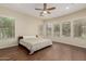 Bright bedroom with hardwood floors, ceiling fan, and many windows bringing in natural light at 13052 W Mine Trl, Peoria, AZ 85383