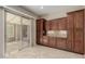 Butler's pantry with dark wood cabinets, countertop space, and backyard access at 13052 W Mine Trl, Peoria, AZ 85383