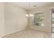 Bright dining area with a chandelier and access to the backyard through sliding glass doors at 13052 W Mine Trl, Peoria, AZ 85383
