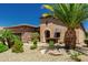 Lush desert landscaping complements this lovely home with a front facing two car garage and an arched front door at 13052 W Mine Trl, Peoria, AZ 85383