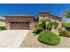 Charming single-story home with a two-car garage, desert landscaping, and a well-maintained yard at 13052 W Mine Trl, Peoria, AZ 85383