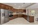 Updated kitchen with stainless steel appliances, granite countertops, and dark wood cabinets at 13052 W Mine Trl, Peoria, AZ 85383