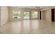 Spacious living room with neutral tile flooring, backyard access, and large windows at 13052 W Mine Trl, Peoria, AZ 85383