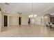 Spacious living room with tile floors, built-in shelves, ceiling fan, and chandelier at 13052 W Mine Trl, Peoria, AZ 85383