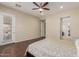 Large main bedroom with hardwood flooring, backyard access, and a ceiling fan at 13052 W Mine Trl, Peoria, AZ 85383