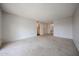 Open bedroom with neutral carpet and doorway that leads to the bathroom and vanity at 13618 N 98Th Ave # C, Sun City, AZ 85351