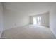 Large bedroom featuring sliding glass doors to the outside and neutral carpeting at 13618 N 98Th Ave # C, Sun City, AZ 85351