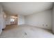 Bedroom with neutral carpet, built-in vanity, storage cabinets, and a closet at 13618 N 98Th Ave # C, Sun City, AZ 85351