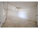 Spacious bedroom with neutral carpet, ceiling fan, and a window providing natural light at 13618 N 98Th Ave # C, Sun City, AZ 85351