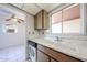 Traditional kitchen featuring a double basin sink, tile countertops and backsplash, and light wood cabinetry at 13618 N 98Th Ave # C, Sun City, AZ 85351
