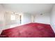 Spacious living room featuring red carpeting and tile flooring, offering versatile layout options at 13618 N 98Th Ave # C, Sun City, AZ 85351