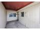 A covered patio with a secure gate and a light fixture, perfect for relaxing outdoors at 13618 N 98Th Ave # C, Sun City, AZ 85351