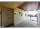 A covered patio with a secure gate and a light fixture, perfect for relaxing outdoors at 13618 N 98Th Ave # C, Sun City, AZ 85351